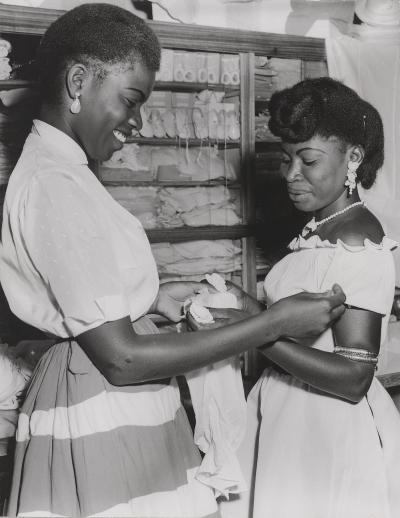 A Congolese saleswoman and customer in a shop in Kinshasa (ca. 1957)